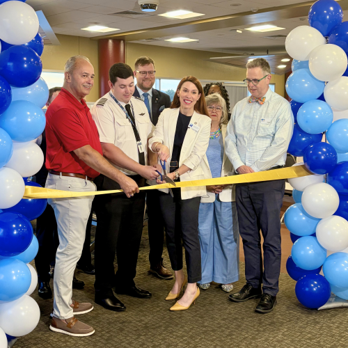 Mike Stewart, PSA Pilot, Amanda Marko, Eric Sichau, Evelyn Powers, Mayor Joe Cobb, and other dignitaries gather to cut the ribbon on DFW service at ROA