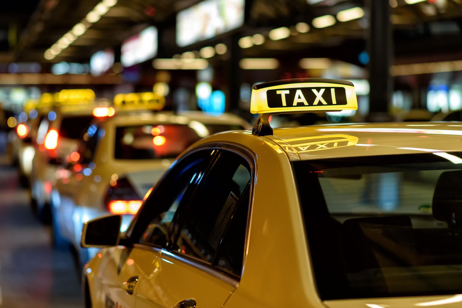 A row of taxis lined up on a street